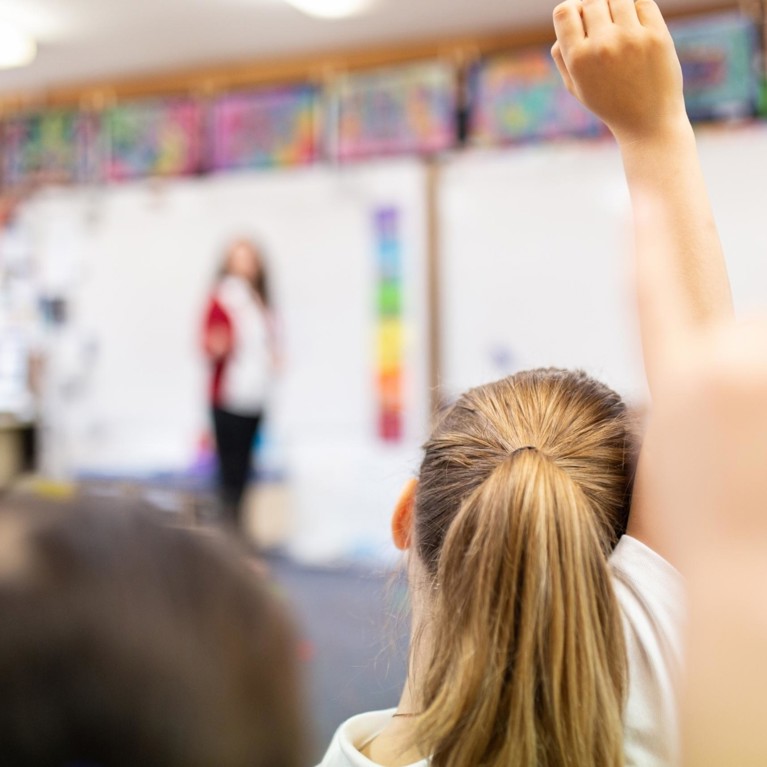 Student raising hand in class