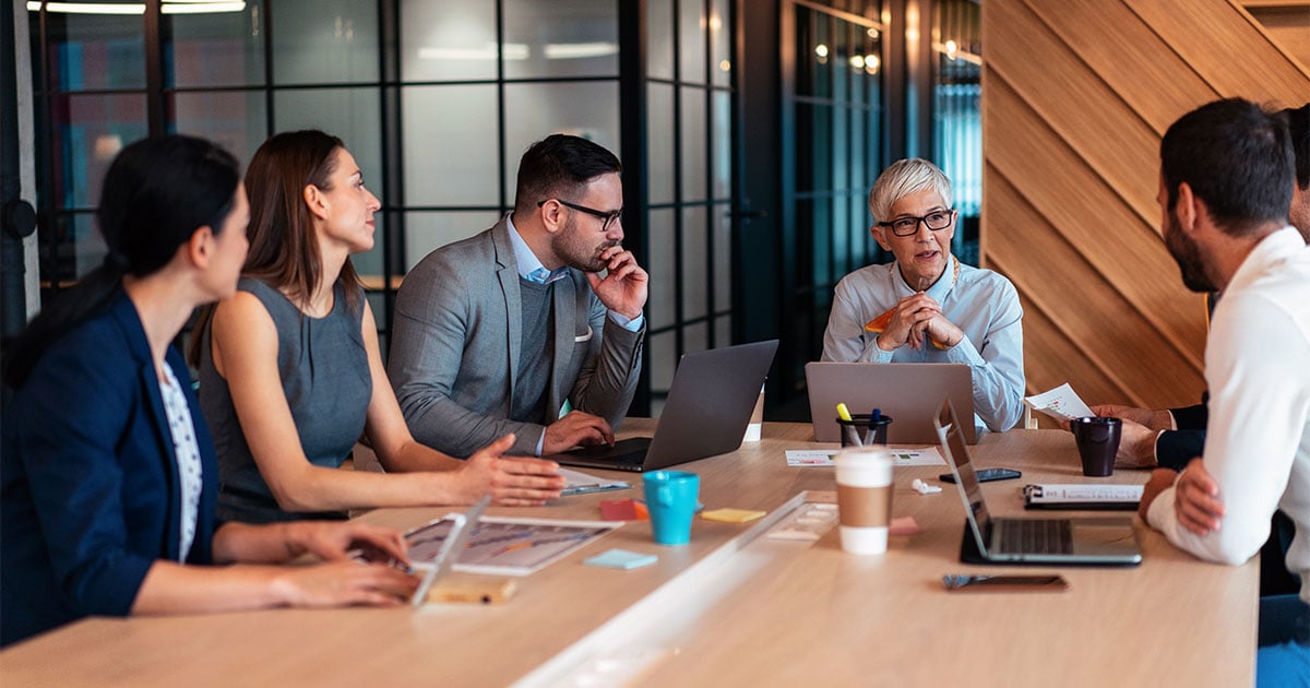 People in a meeting seated around a table