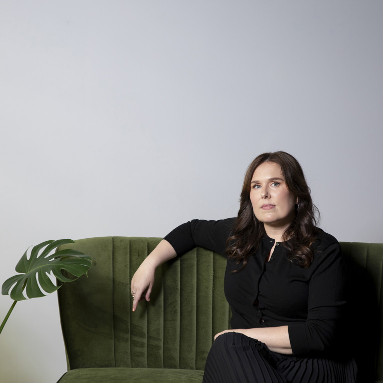 Cassie Stroud sitting on green couch.
