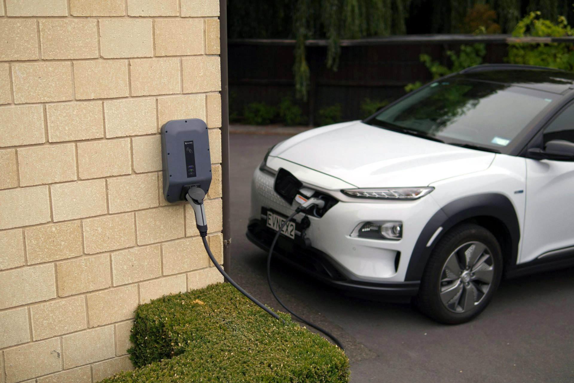 EV plugged into a charger at home. Households in outer suburbs and regional towns are heavily exposed to fuel price pain – but often have easy access to charging an EV at home. Ed Harvey/Pexels, CC BY-NC-SA