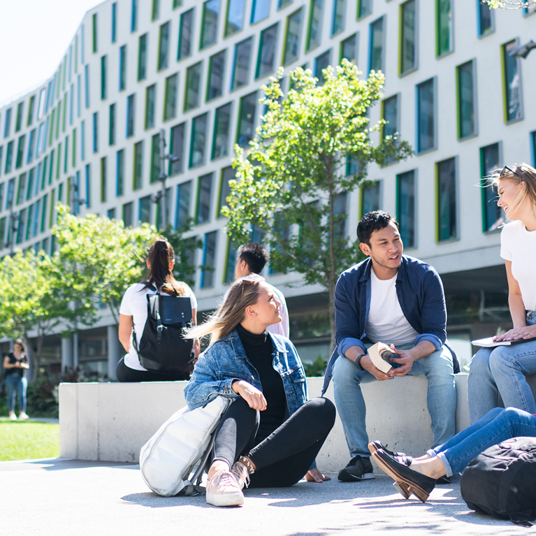 Students sitting on the Alumni Green