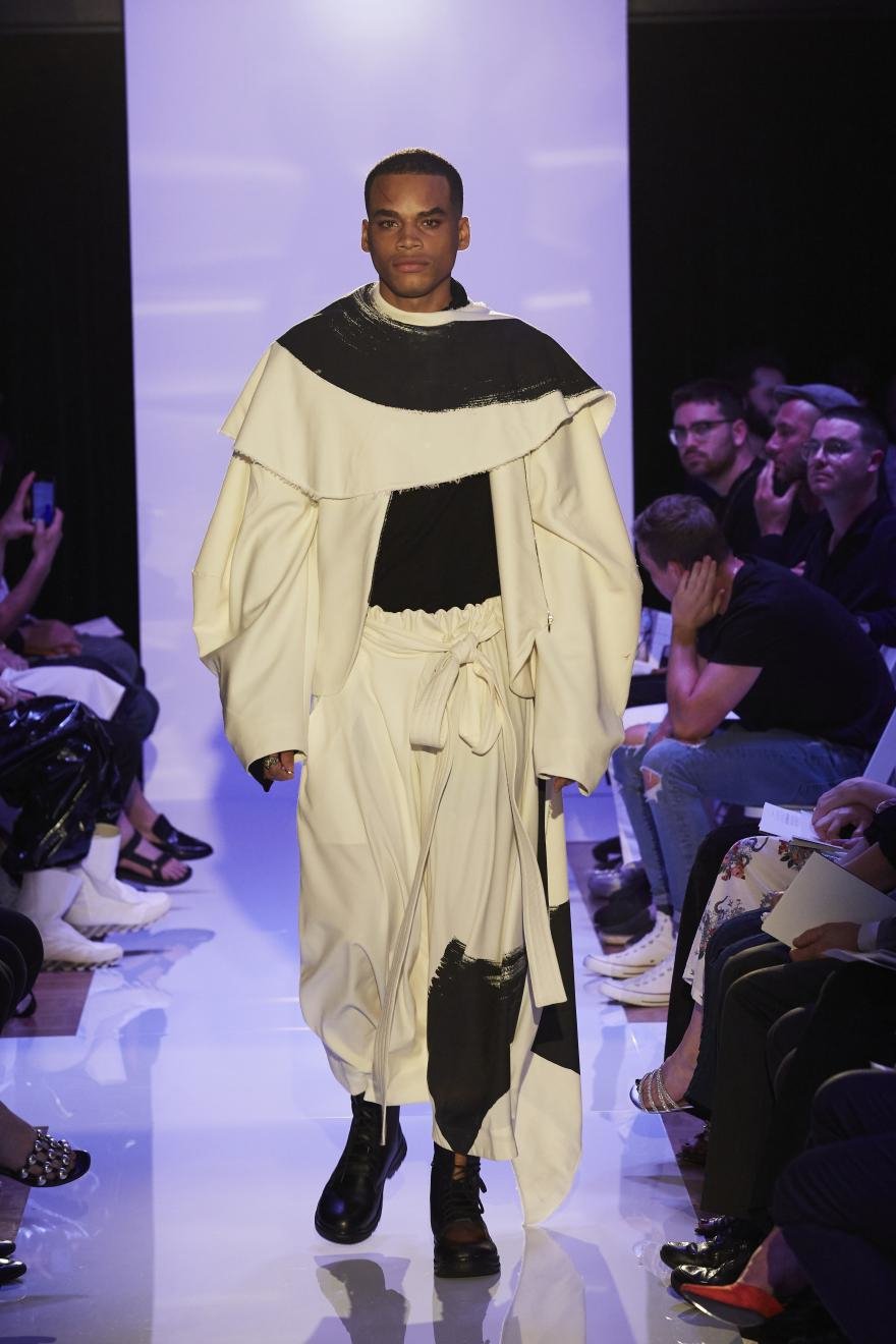 Black and white draped menswear on the runway