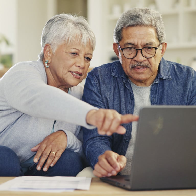 Senior, couple and planning on laptop in living room with document for finances, investment or retirement. By Azeemud/peopleimages.com Image Adobe Stock