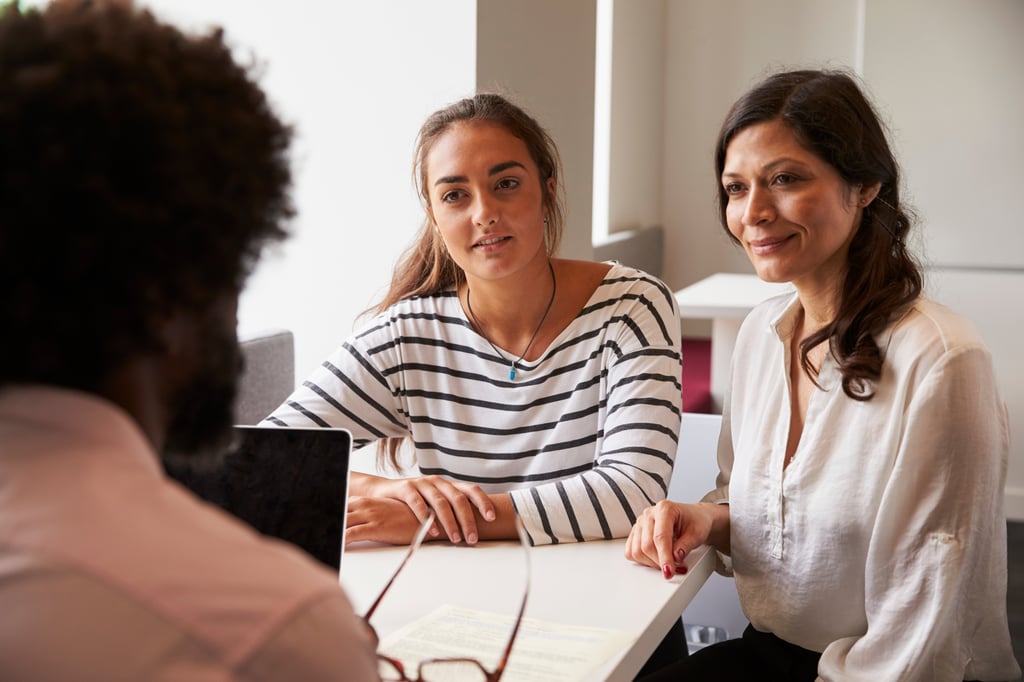 Legal guardian and under-18 UTS international student in conversation with staff.