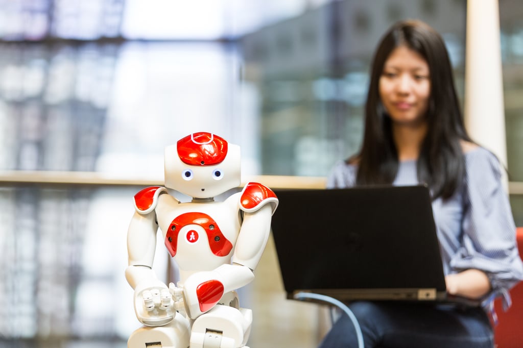 University of Technology Sydney student working with a small robot.