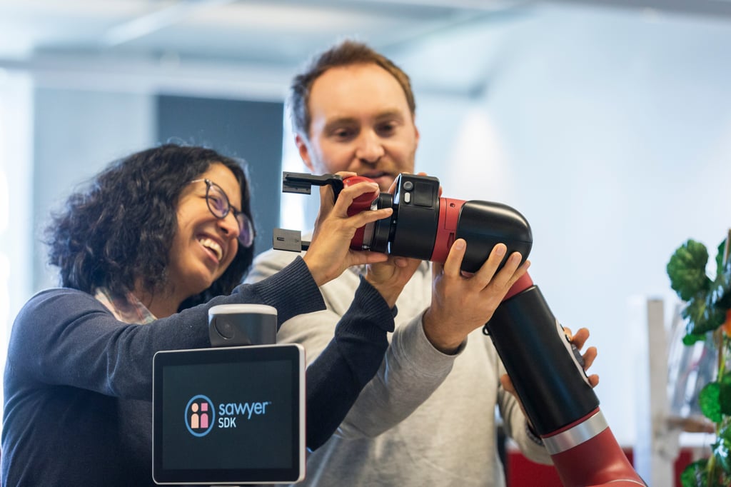Female and male research staff working on robotics