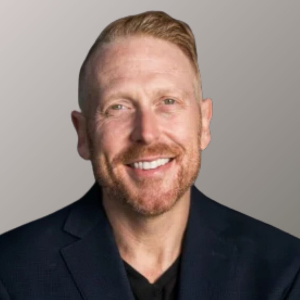 Portrait of Craig Scroggie. He's wearing a black dress shirt.