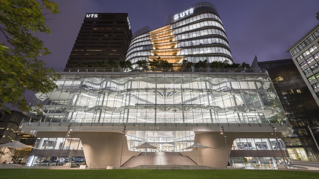 University of Technology Sydney Central building at night.