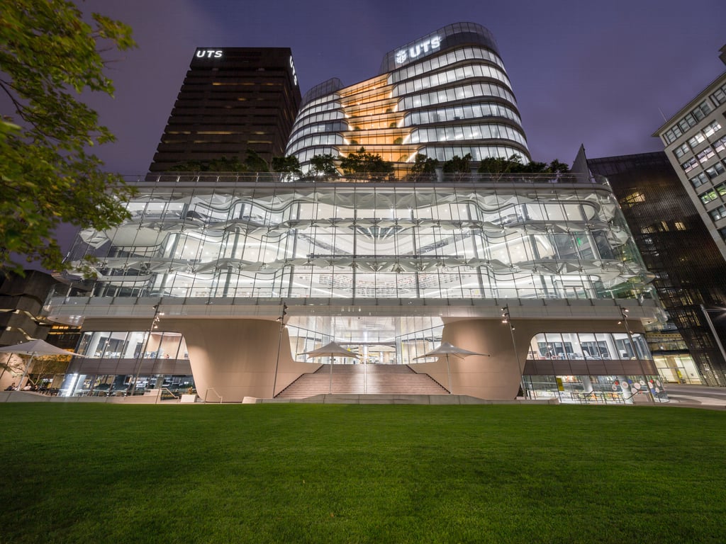 University of Technology Sydney Central building at night.
