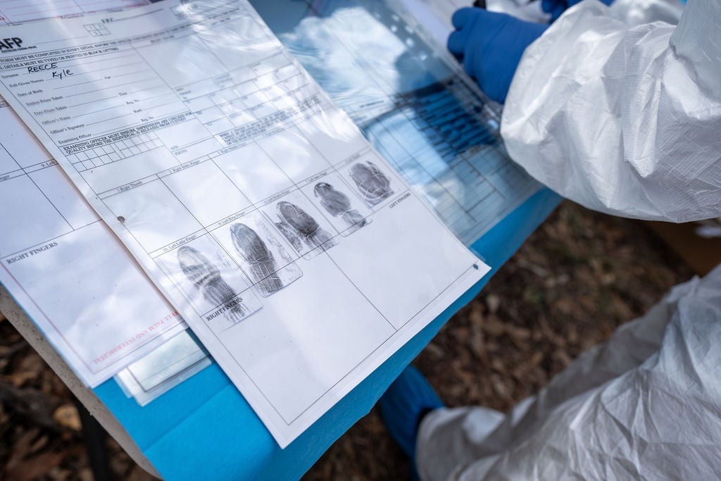 Close-up of a piece of paper showing a person's fingerprints in black ink.