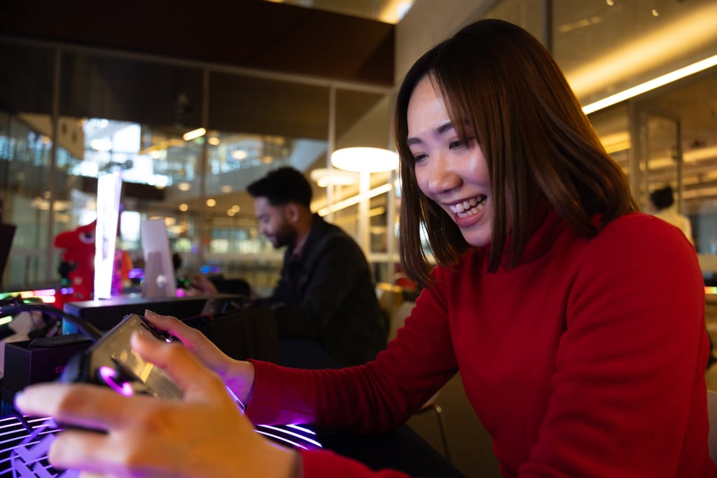 Male and female student gaming at UTS Tech Fest.