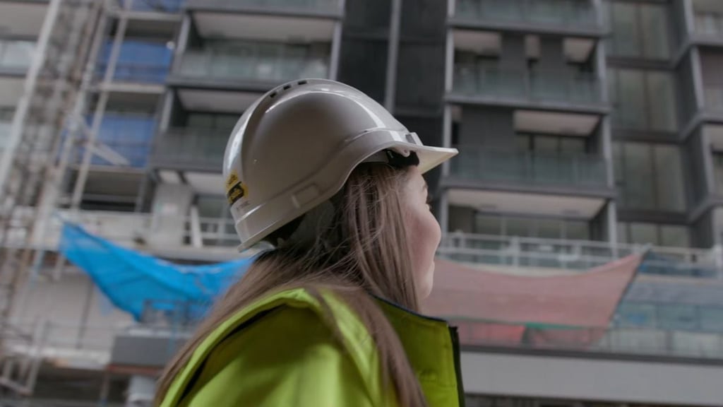 Woman wearing safety gear on a construction site.
