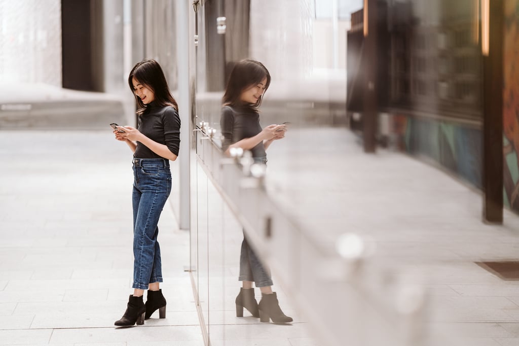 Student checking her phone on the UTS campus.