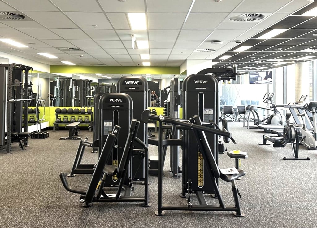 An indoor gym with various pieces of fitness equipment.