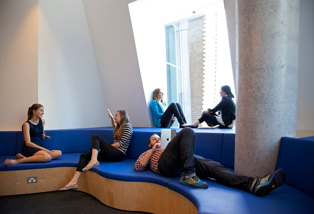 A group of university students relax indoors on campus.