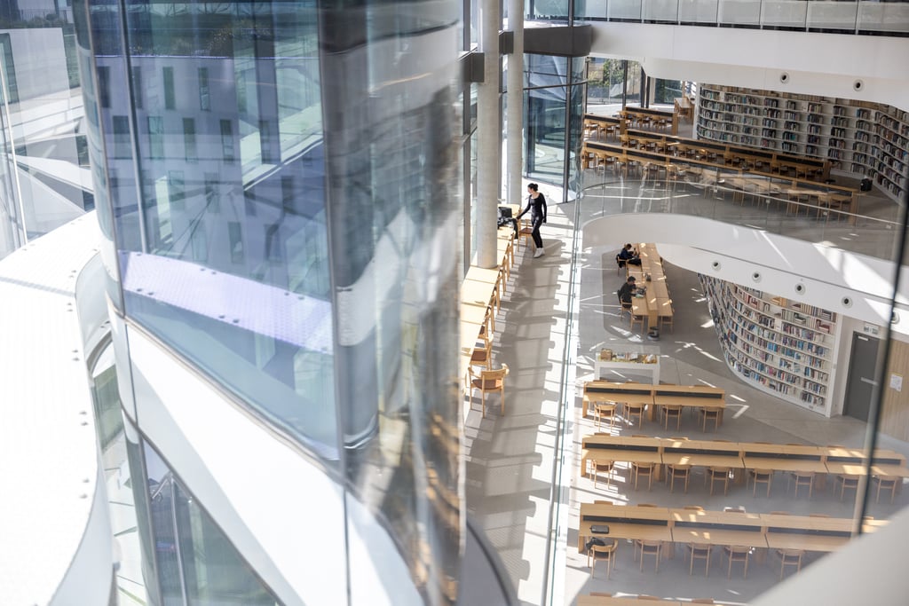The University of Technology Sydney Library reading room from above, looking into the space with students at desks and bookshelves in the background.
