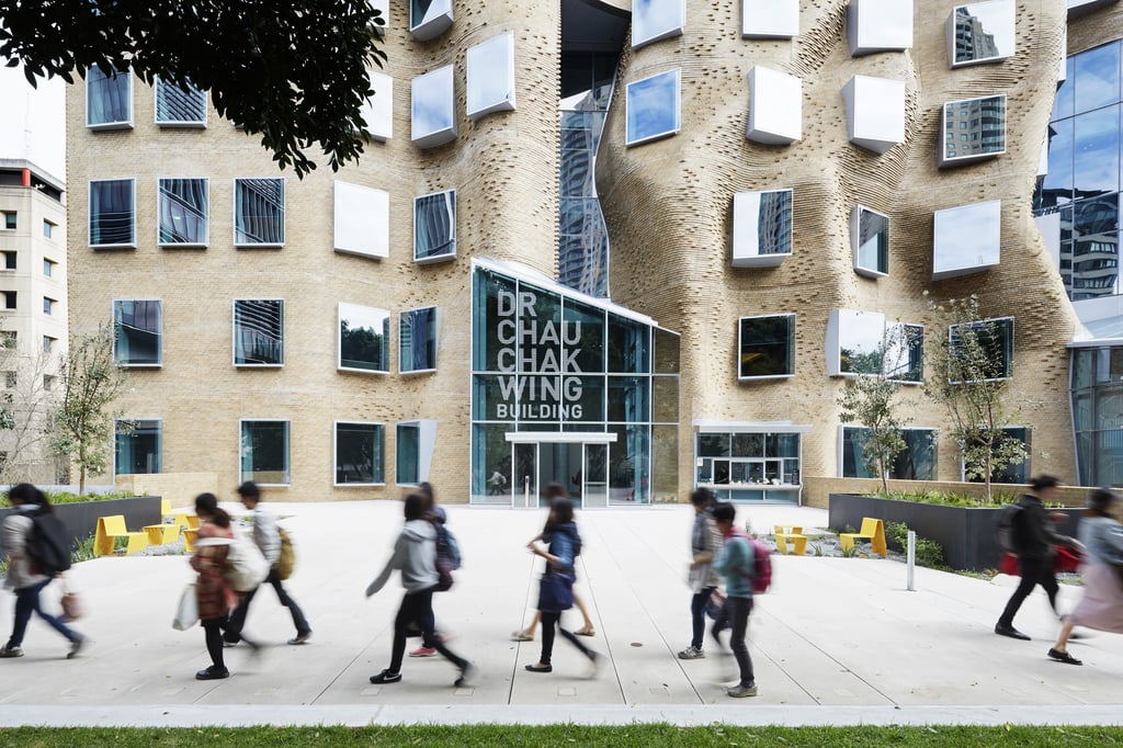 Students walking along the pathway in front of the Chau Chak Wing Business Buillding