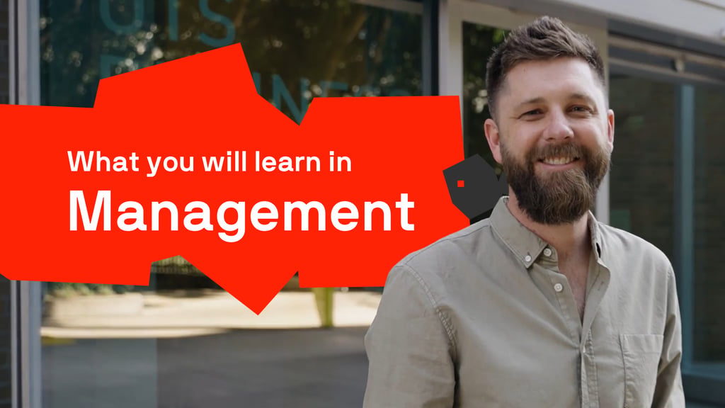 A smiling man with a beard standing outdoors near a building with glass windows. Overlaid on the image is a bold red graphic with the text: "What you will learn in Management”.