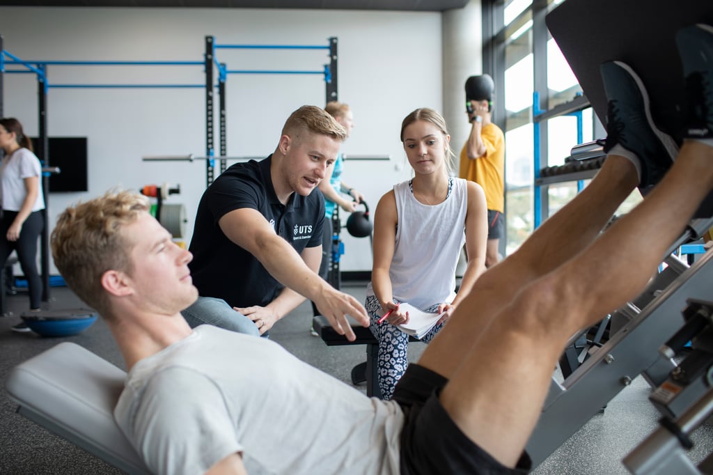 Instructor and students in a gymnasium.
