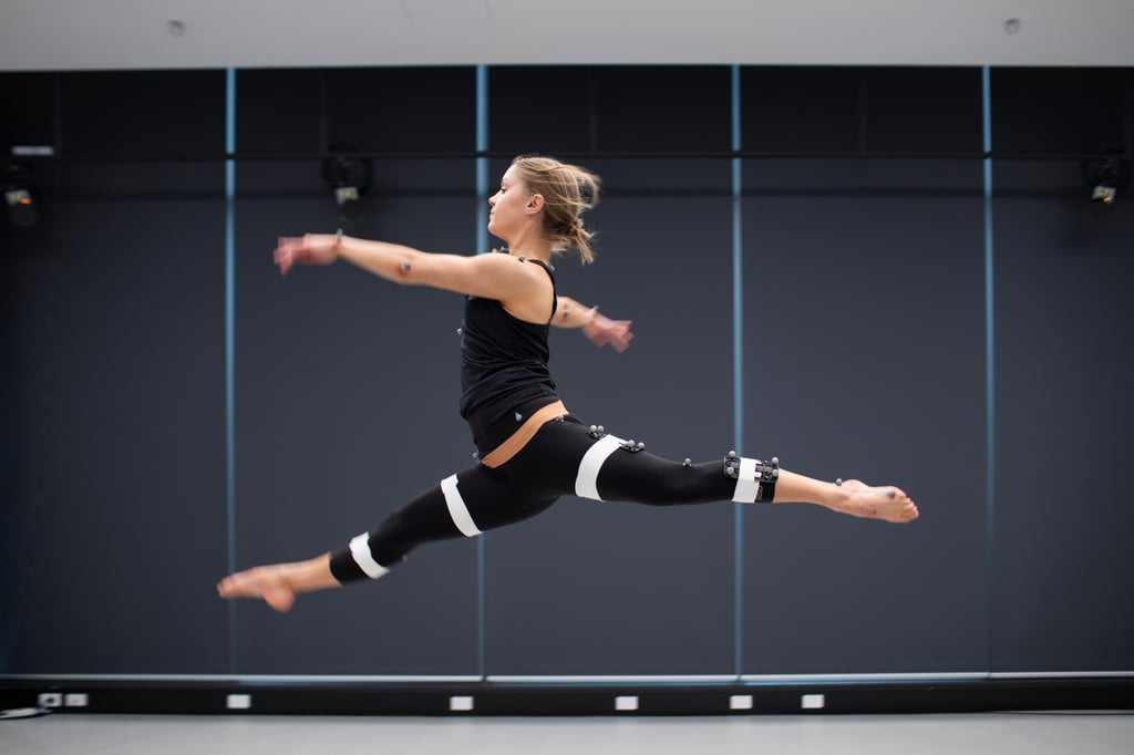 Woman jumping with motion sensors attached to her body