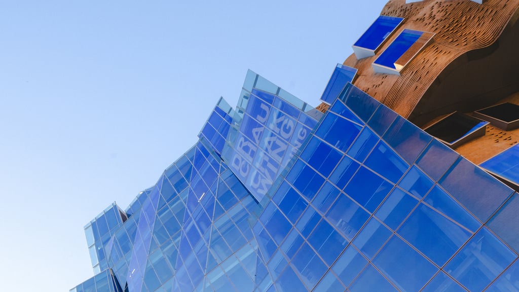 External view of the glass wall side of the Doctor Chau Chak Wing Building at the University of Technology Sydney.