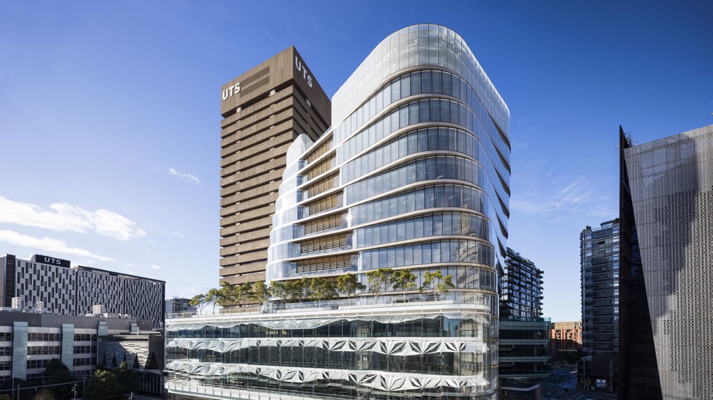 Panoramic view of the glass facade of UTS library and UTS central, with the UTS tower in the background