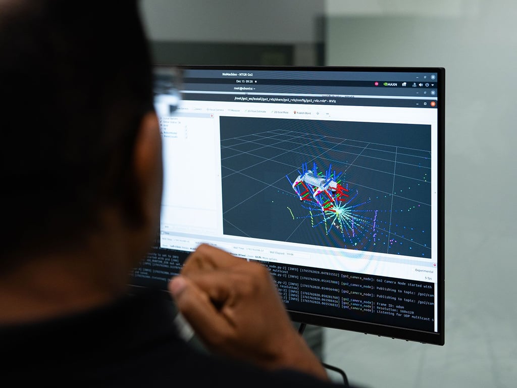 A member of the UTS Robotics Institute views a computer screen that shows a map of the sensors on the robot guide.