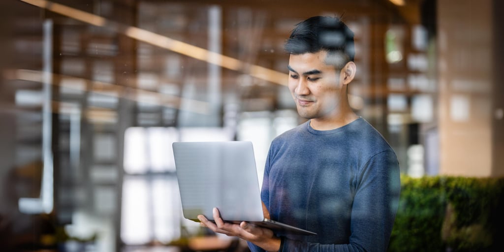 Young man looking at his laptop