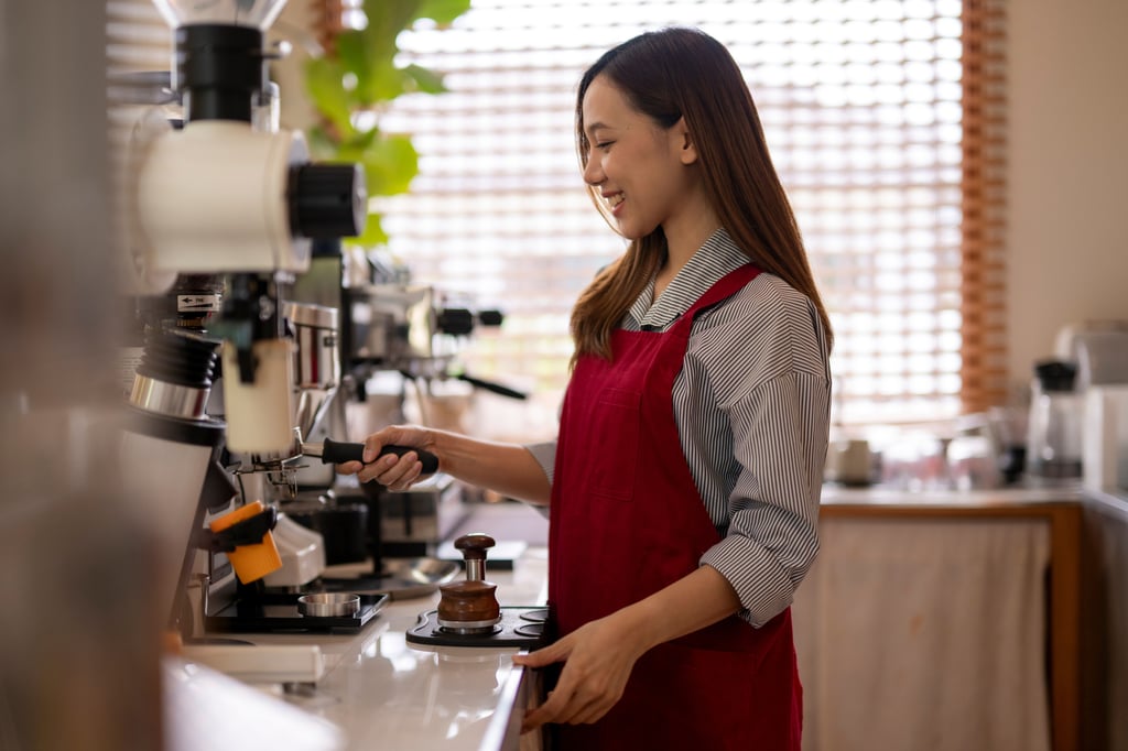 Smiling woman working at a cafe.