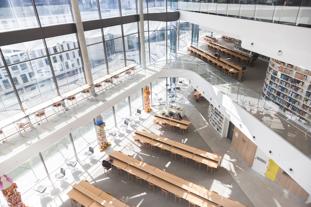 Aerial view of the UTS Library reading room, showing desks, study areas and shelves with books.