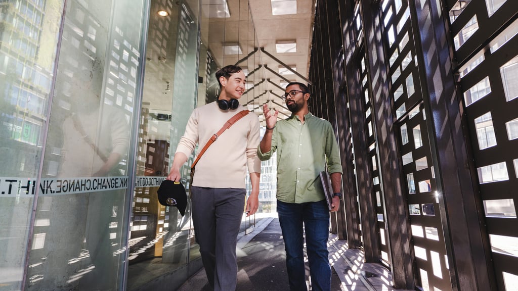 Two students walking through campus at the University of Technology Sydney.