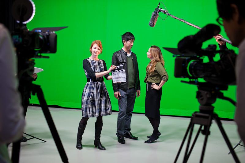 Students shooting video in a green screen studio.