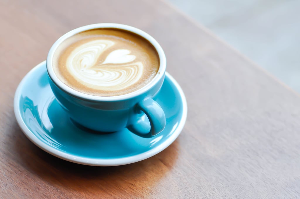 Flat white coffee in a light blue cup and saucer
