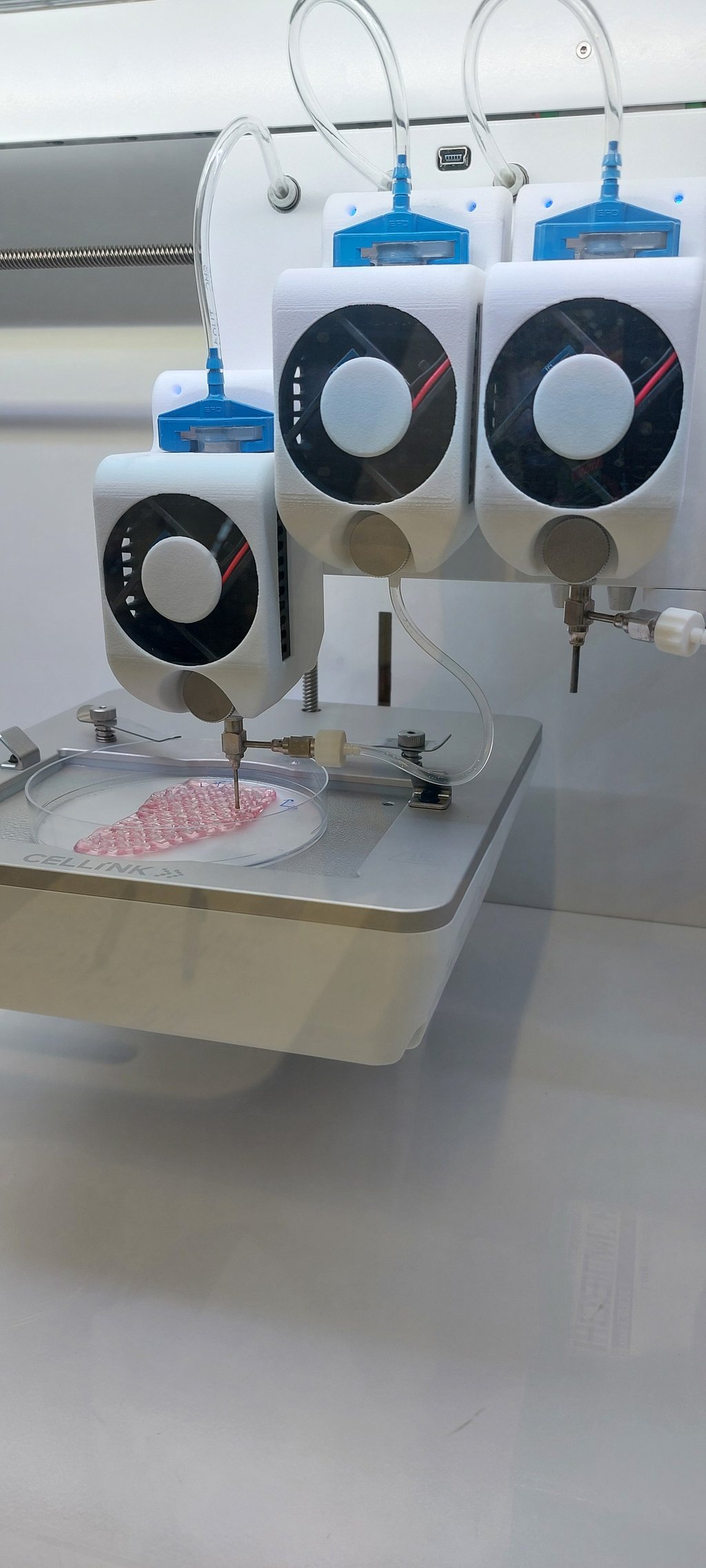 A 3D printer printing a pink substance into a mesh