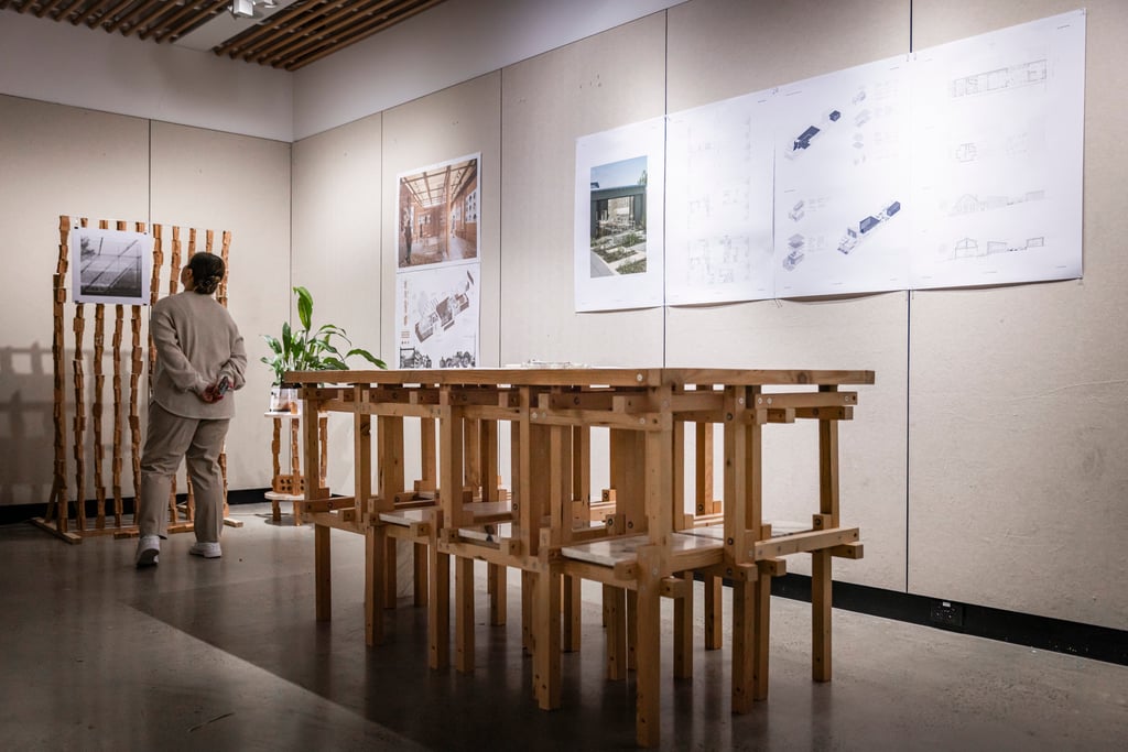 A person reviewing the work of DAB architecture students.