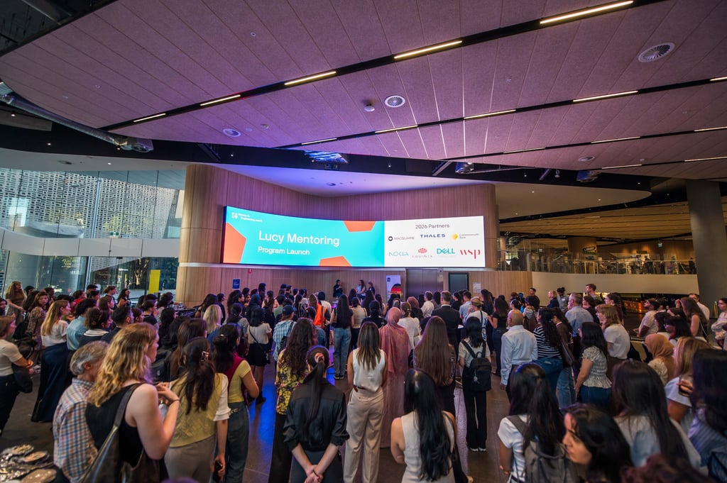 Large crowd facing panel at a launch event at UTS.