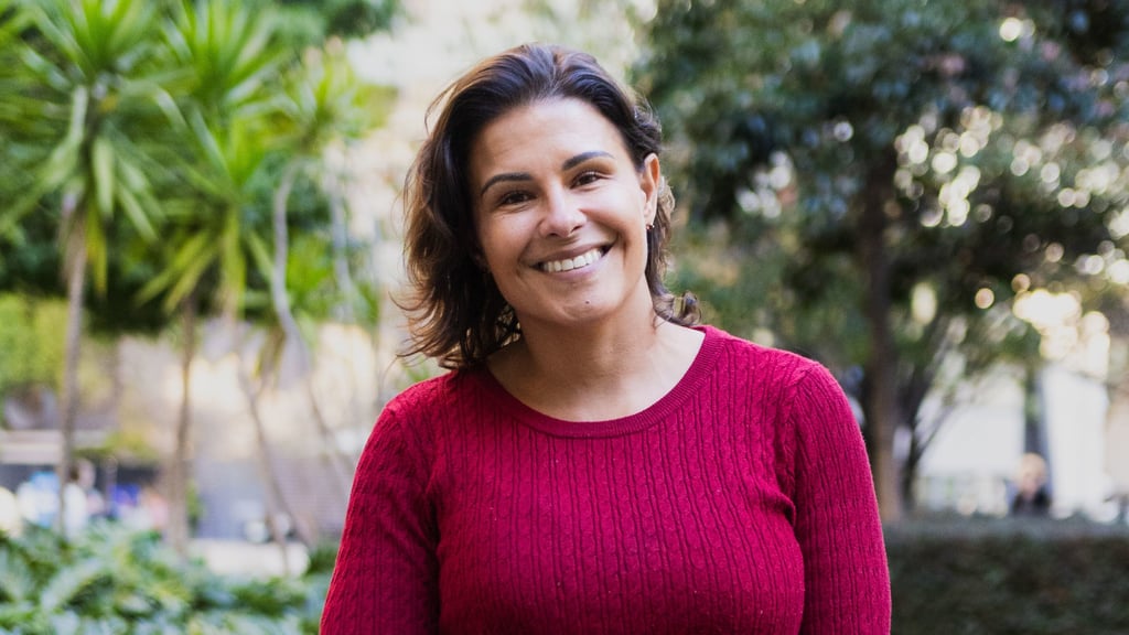Kristal Kinsela wearing a red top and smiling and looking at the camera