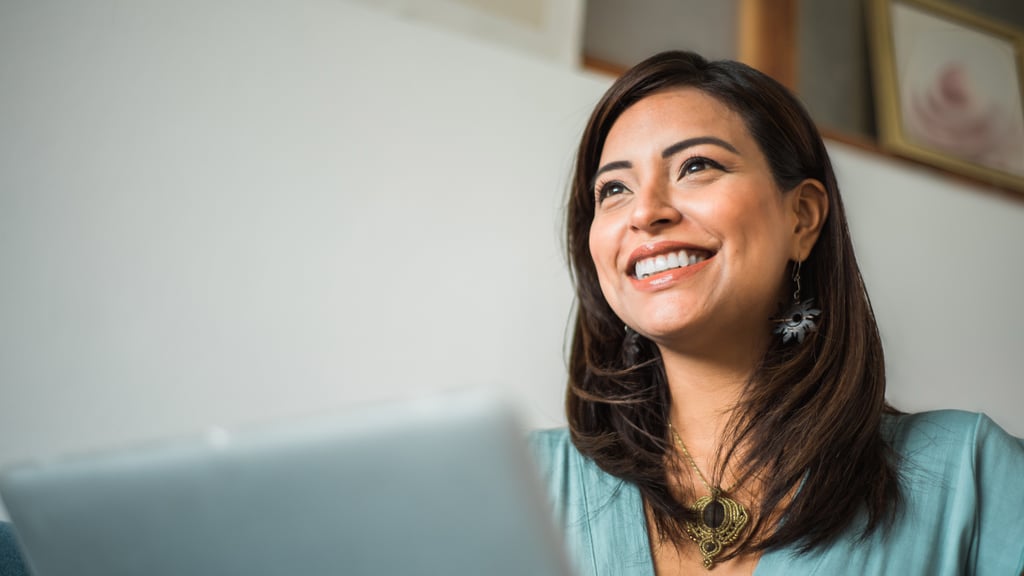 Smiling woman working on a laptop