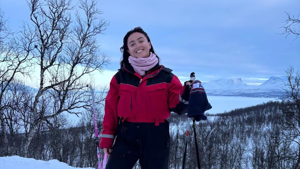 Girl in red jackeet skiing on snowy mountain