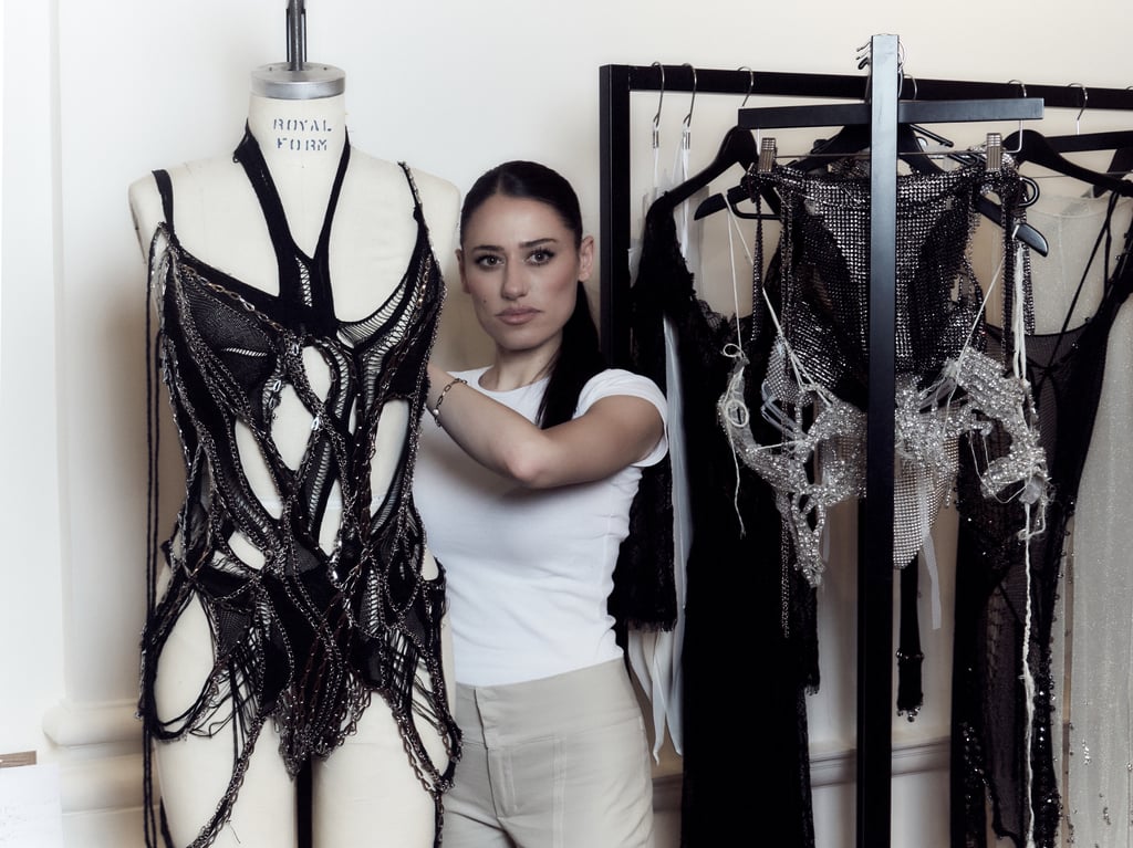 Fashion designer and University of Technology Sydney graduate Caroline Reznik standing beside a mannequin.
