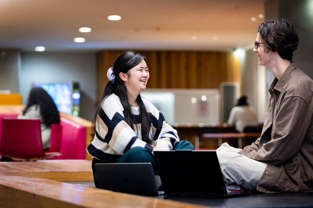 UTS graduate Yuka chatting with a student