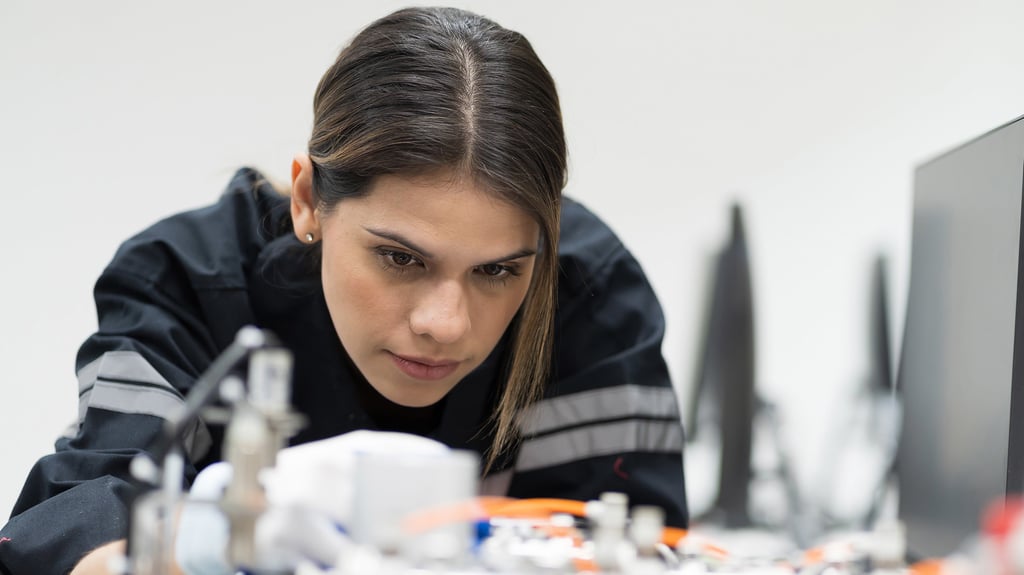 Female engineer training an artificial intelligence robot.
