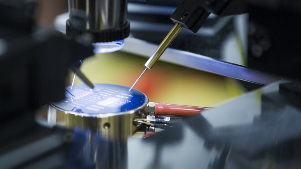 A close-up view of a machine meticulously working on a small object, showcasing intricate details and precision in action.