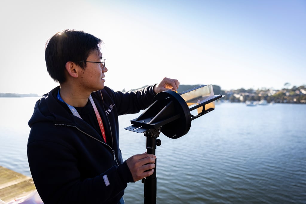 A researcher standing with an ultra-wideband antenna