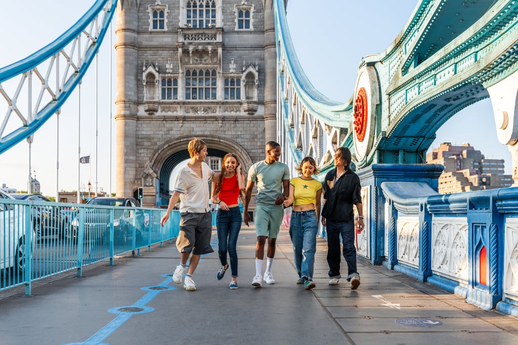 Multiracial group of happy young friends bonding in London city