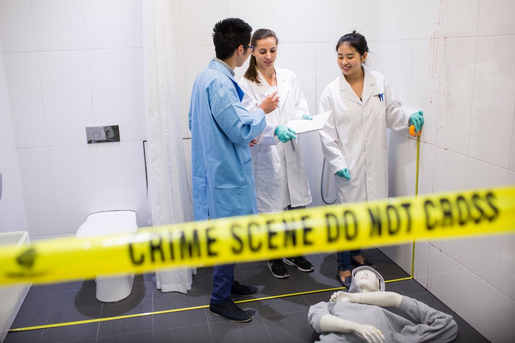Three students in a simulated crime scene.