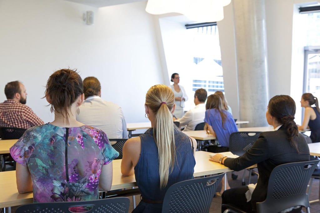 UTS students listening to a lecturer in a classroom.