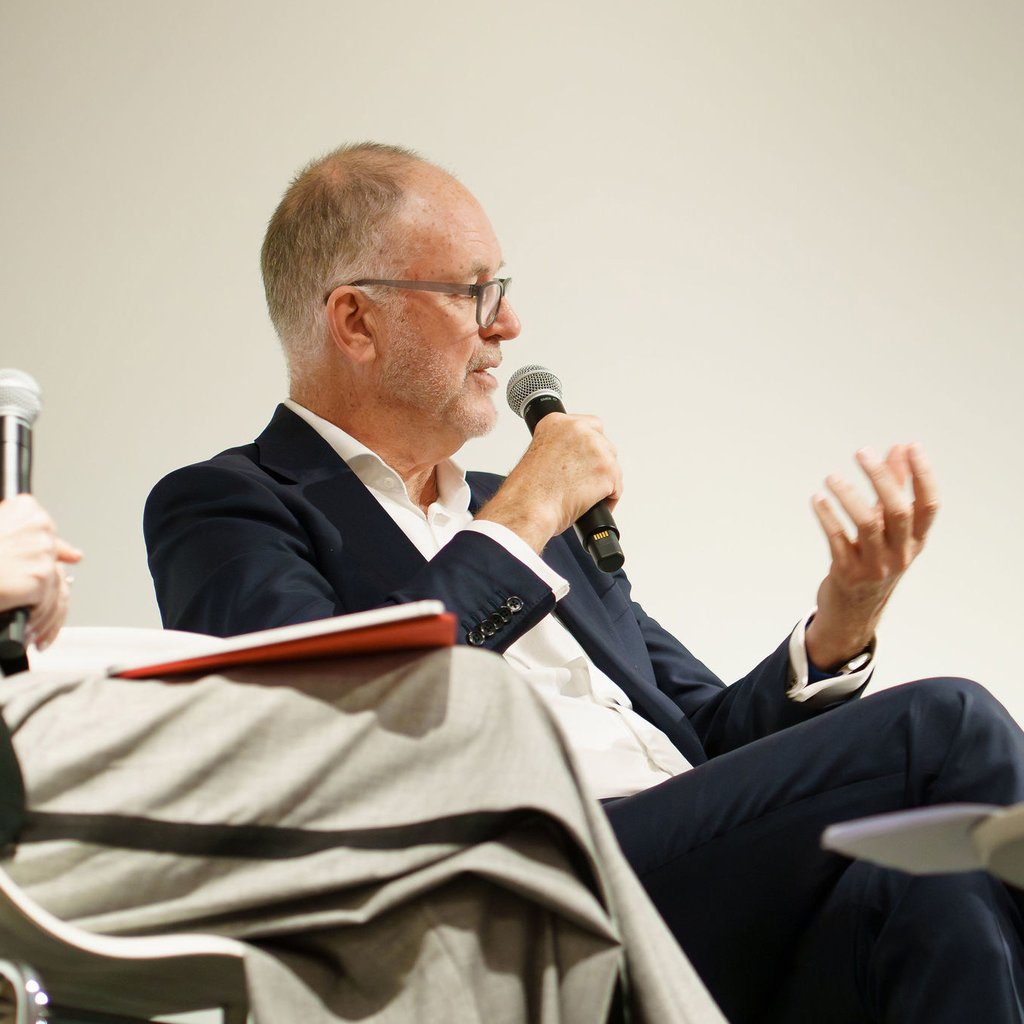 Image of Michael Rose holding a microphone