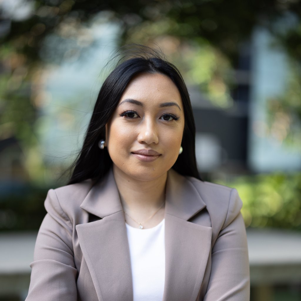 Arhita wearing a light brown blazer over a white top