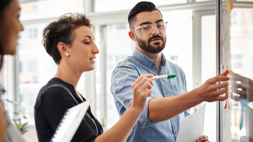 Professionals collaborating at a whiteboard